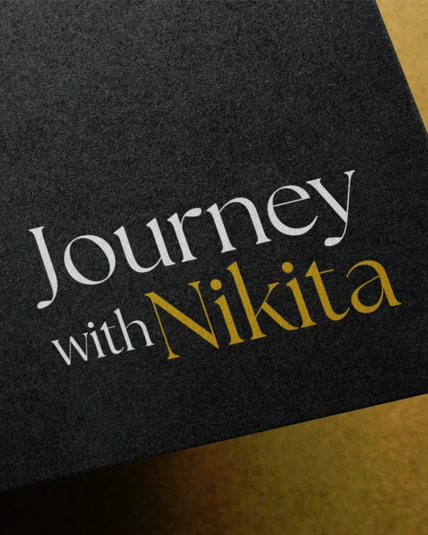 Close-up of a branded Journey Nikita design featuring elegant typography in white and gold
